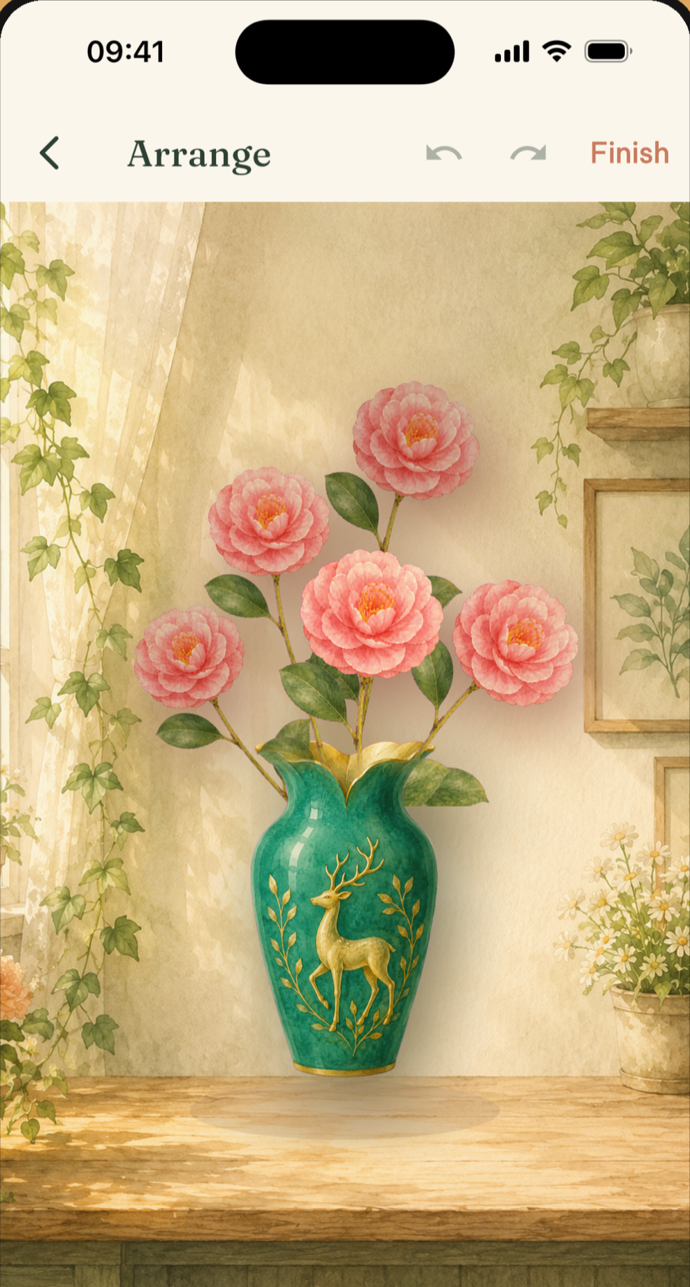 The Bloomette arrange screen: pink camellias being placed into a green deer vase.